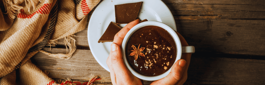 woman holding a cup of homemade hot cocoa