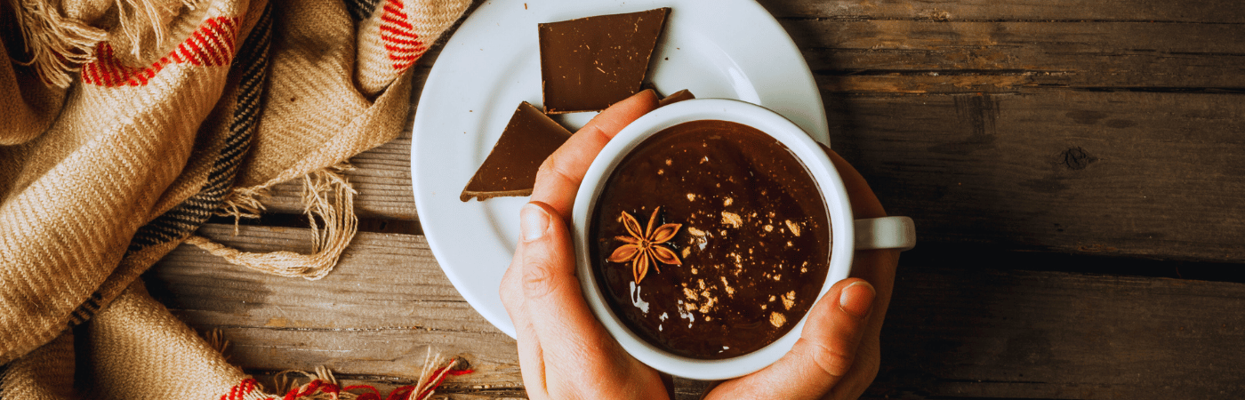 woman holding a cup of homemade hot cocoa