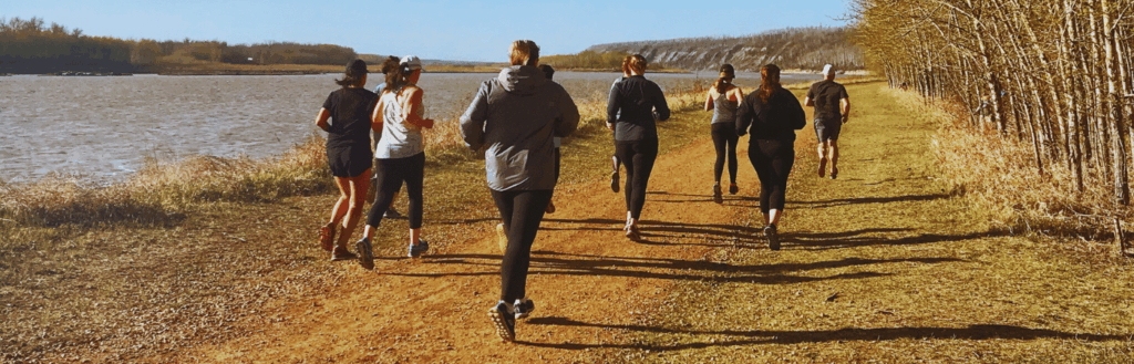 runners running slow along side the Athabasca River in Fort McMurray